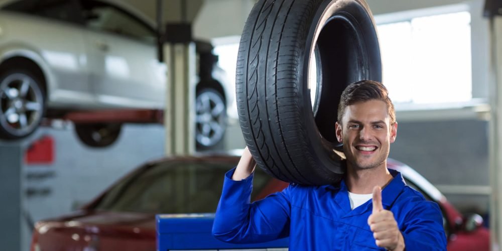 portrait-mechanic-carrying-tyre (1)